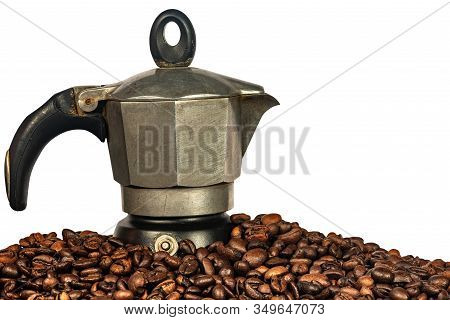 Close-up Of An Old Italian Coffee Maker (moka Pot, Side View) On A Stack Of Roasted Coffee Beans And