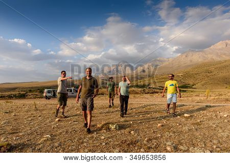 Turkey, Chamard - August 2, 2019: Five Men Walk Along A Valley In The Turkish National Park Aladag W