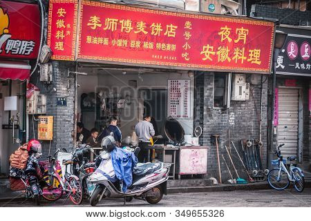 Shanghai, China - November 9, 2019: Noodle local street food on Ninghai East Road close to the city center. These street food typical for old residential district also known as a shikumen houses.