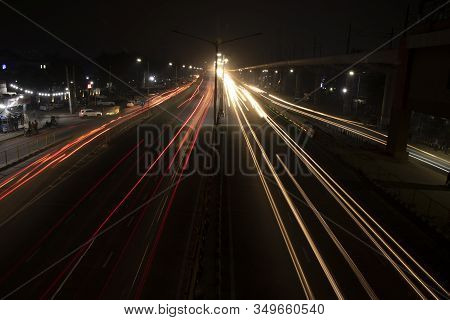 Speed Traffic Light Trails On Highway, Long Exposure, Urban Background And Dark Sky