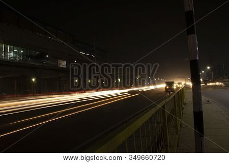 Speed Traffic Light Trails On Highway, Long Exposure, Urban Background And Dark Sky