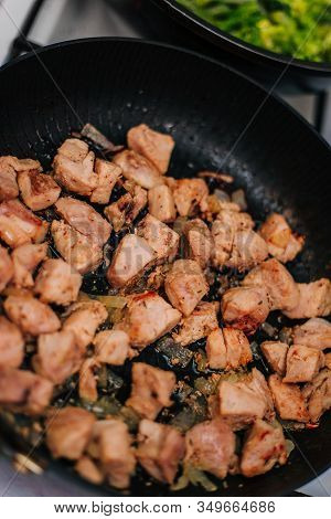 Cooking Meat In A Pan With Onions. Fried Chicken. Diced Meat