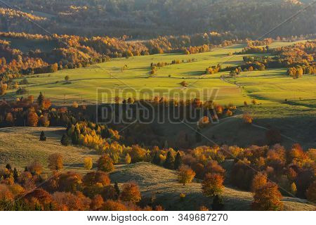 Beautiful Aerial View Of An Autumn Landscape Of A Green Valley With Colored Trees In The Golden Hour