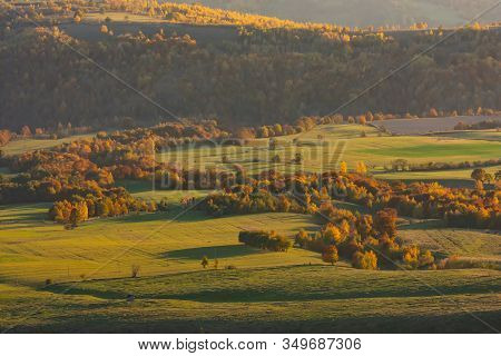 Beautiful Aerial View Of An Autumn Landscape Of A Green Valley With Colored Trees In The Golden Hour