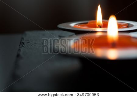Candle light in tray on a black table