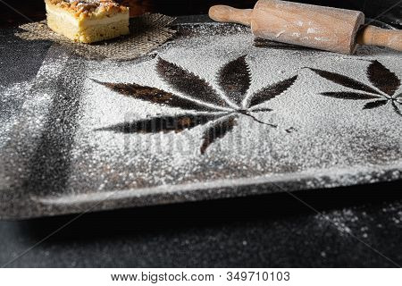 Cooking Cannabis Food. Trail Of Cannabis Leaf On White Flour On A Rust Table. Battledore. On A Burla