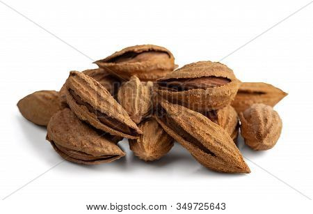 A Bunch Of Selected Dried Inshell Almonds. Isolated On A White Background. Selective Focus.