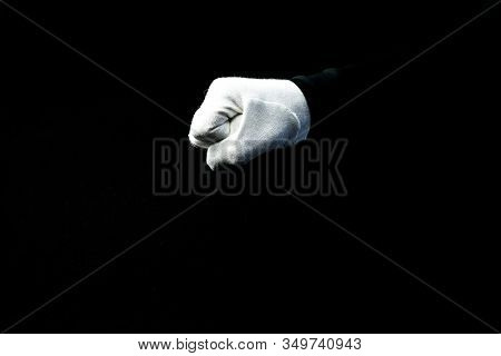 A Hand Wearing White Glove On Black Background Showing A Fist