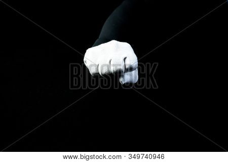 A Hand Wearing White Glove On Black Background Showing A Fist