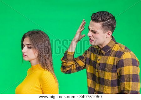 Man Extremely Angry At Girlfriend, Shouting At Her, Warnig With Fist, She Stands Back To Her, Not Pa