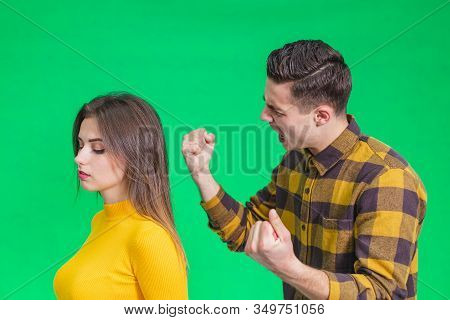 Man Extremely Angry At Girlfriend, Shouting At Her, Warnig With Fist, She Stands Back To Her, Not Pa