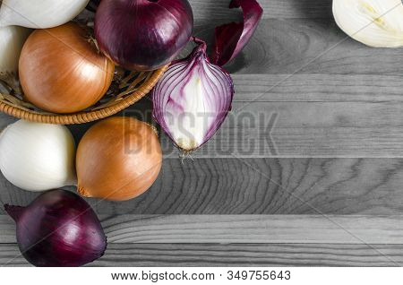 Large Bulbs Of Yellow, Red And White Onions Close-up On A Black And White Background Place Under The