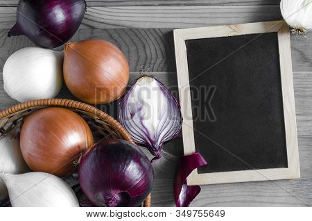 Large Bulbs Of Yellow, Red And White Onions Close-up On A Black And White Background Place Under The