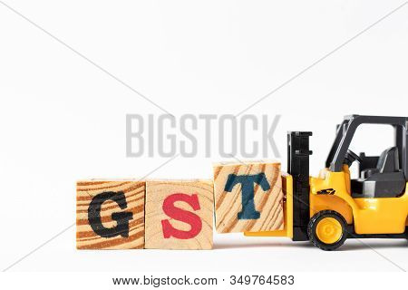 Toy Forklift Hold Wood Letter Block T To Complete Word Gst (abbreviation Of Goods And Service Tax) O