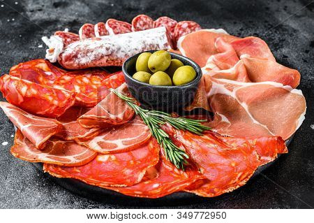Cured Meat Platter Of Traditional Spanish Tapas. Chorizo, Jamon Serrano, Lomo And Fuet. Black Backgr