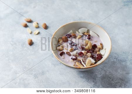 Bowl Of Granola With Yogurt, Nuts, Cranberry And Cocoanut. Concept For A Tasty And Healthy Meal. Sto