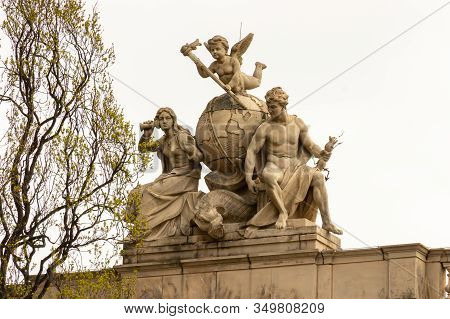 Gerlitz, Germany - April, 2019: Statues On The Roof Of The City Post Office Building, A Monument Of 
