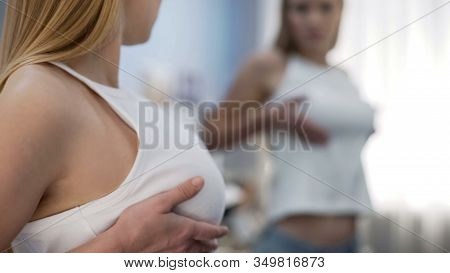 Young Woman Checking Breast In Mirror, Cancer Self-examination, Health Danger