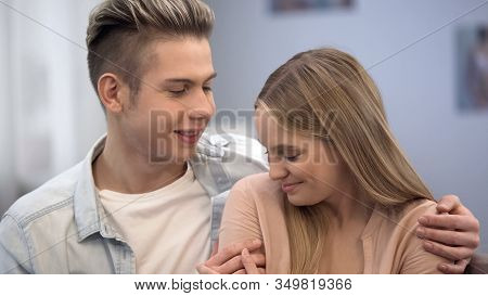 Boy Embracing Shy Girl, Looking At Her With Love, Inexperience In Teen Relations