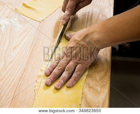 Chef Rolling Dough With A Pasta Machine. Pasta Maker Machine.