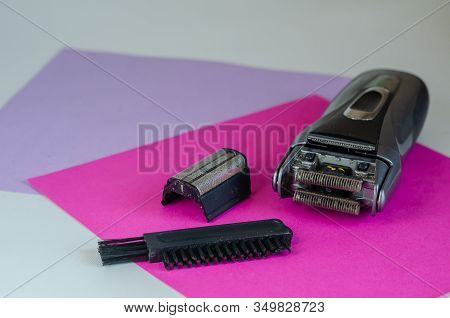 Disassembled Electric Shaver And Brush For Cleaning On The Table. Cleaning A Dirty Electric Shaver O