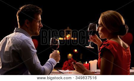 Male And Lady Having Dinner In Restaurant Tasting Red Wine, Couple On Blind Date