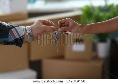 Moving To New Apartment And Receiving Keys To It. Close Up Male Hands Pass Keys To Female Hands. Han