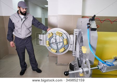 Men Workers Get Carpet From An Automatic Washing Machine And Put In In Dryer In The Laundry Service