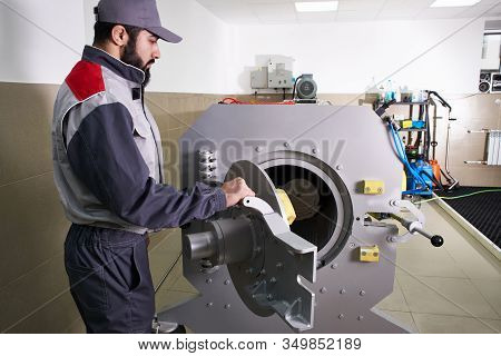 Men Workers Get Carpet From An Automatic Washing Machine And Put In In Dryer In The Laundry Service