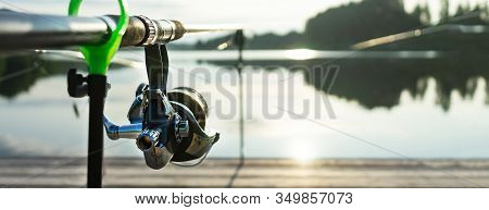Carp Fishing On Beautiful Blue Lake With Carp Rods And Rod Pods In The Summer Morning. Fishing From 