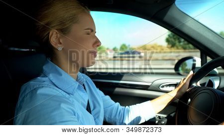 Woman Screwing Up Her Eyes While Driving, Blurred Vision, Risk Of Car Accident