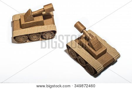 Two Toy Tanks Made By Children From Corrugated Cardboard Are Fighting. Toy Cardboard Tanks Isolated 