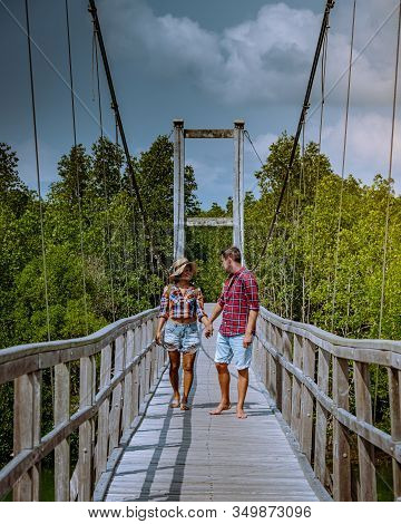 Muko Chumphon National Park, Thailand , Couple Walking On Wooden Deck In The Park With Trees And Man