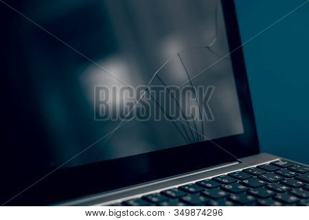 The Screen Laptop Cracked And Damaged. A Silver Laptop With A Broken Tablet With A Cracked Display. 