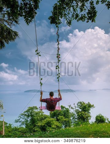 Chumphon Thailand, Khao Matsee Viewpoint View Over Ocean Of Chumphon, Men In Swing Above Ocean