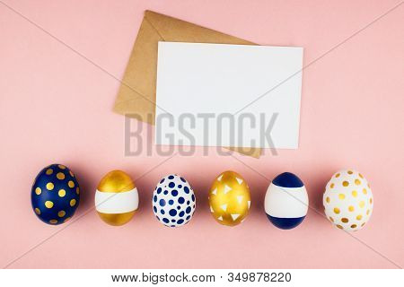 Modern Golden And Blue Spring Easter Eggs With Envelope And Letter Flat Lay On Colorful Pink Backgro