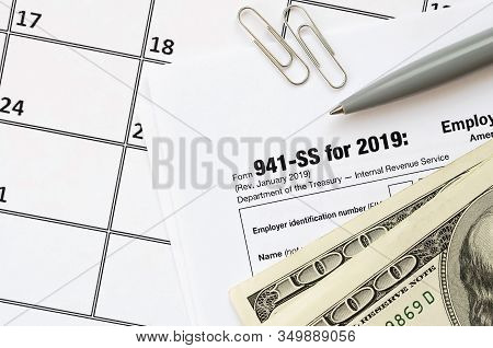 Irs Form 941-ss Employers Quarterly Federal Tax Return Blank Lies With Pen And Many Hundred Dollar B