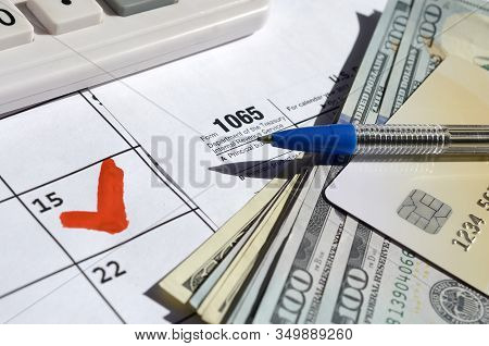 1065 Return Of Partnership Income Blank With Dollar Bills, Calculator And Pen On Calendar Page With 