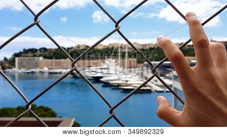 Man Views Yachts Behind Fence, Corrupt Official Looks At Confiscated Property