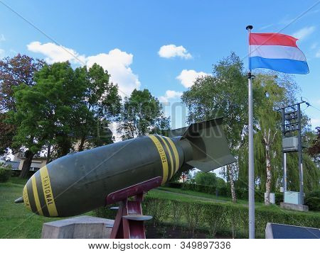 Consdorf, Luxembourg - May 25, 2019. Ww2 Memorial, Actual Aerial Bomb And Luxembourg National Flag B