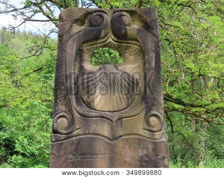 Weilerbach, Luxembourg - May 25, 2019. Small Monument Made Of Local Yellow Sandstone With Camino She