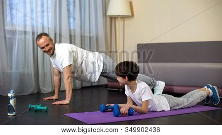 Father And Son Doing Workout At Home, Dad Encouraging Boy To Train, Motivation