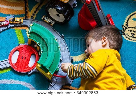 Poznan, Poland - January 19, 2020: Small Young Polish Boy Playing With A Plastic Toy Train Station O