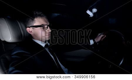 Sad Businessman Sitting In Car Near Girlfriends House, Hesitating To Make Call