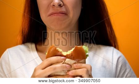 Woman Dissatisfied With Unappetizing Hamburger, Low Food Quality, Closeup