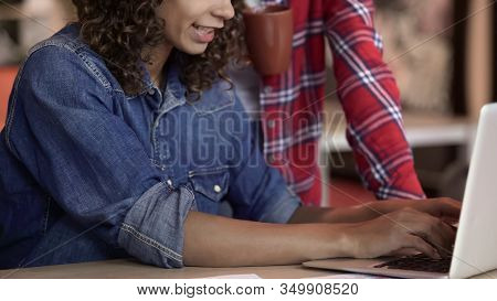 Mixed Race Girl Typing On Laptop And Talking With Colleague, Freelance, Worktime