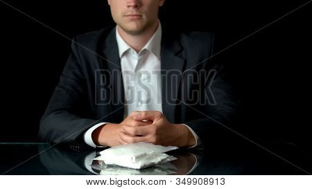 Mafiosi Sitting At Table With Cocaine Packets, Contraband Of Drugs, Smuggling