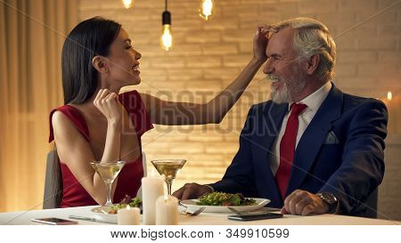 Young Woman Showing Care Old Husband, Insincere Emotions, Fake Love, Romance