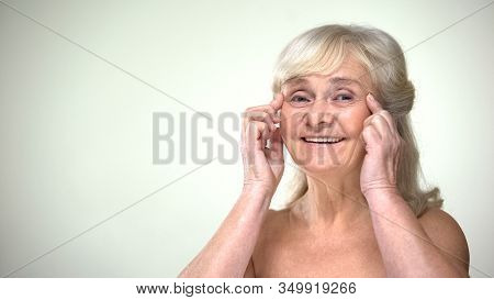 Attractive Old Lady Doing Facial Exercises, Anti-aging Facebuilding For Eyes