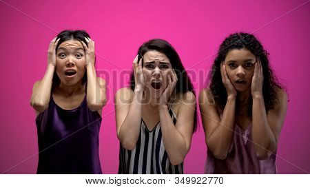 Shocked Multiracial Female Friends Watching Awful Tv Show, Negative Emotions